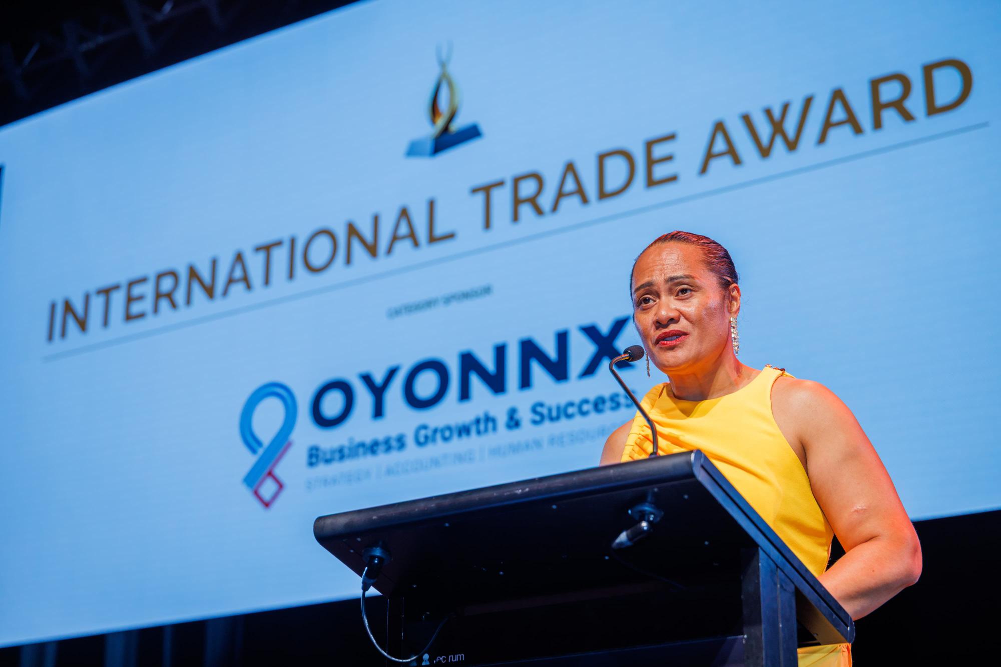Oyonnx accepting an International Trade Award on stage